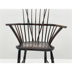 Early 19th century elm, beech and oak Windsor armchair, the plain cresting rail over low stick and hoop back, dished seat, turned supports joined by H stretcher 
