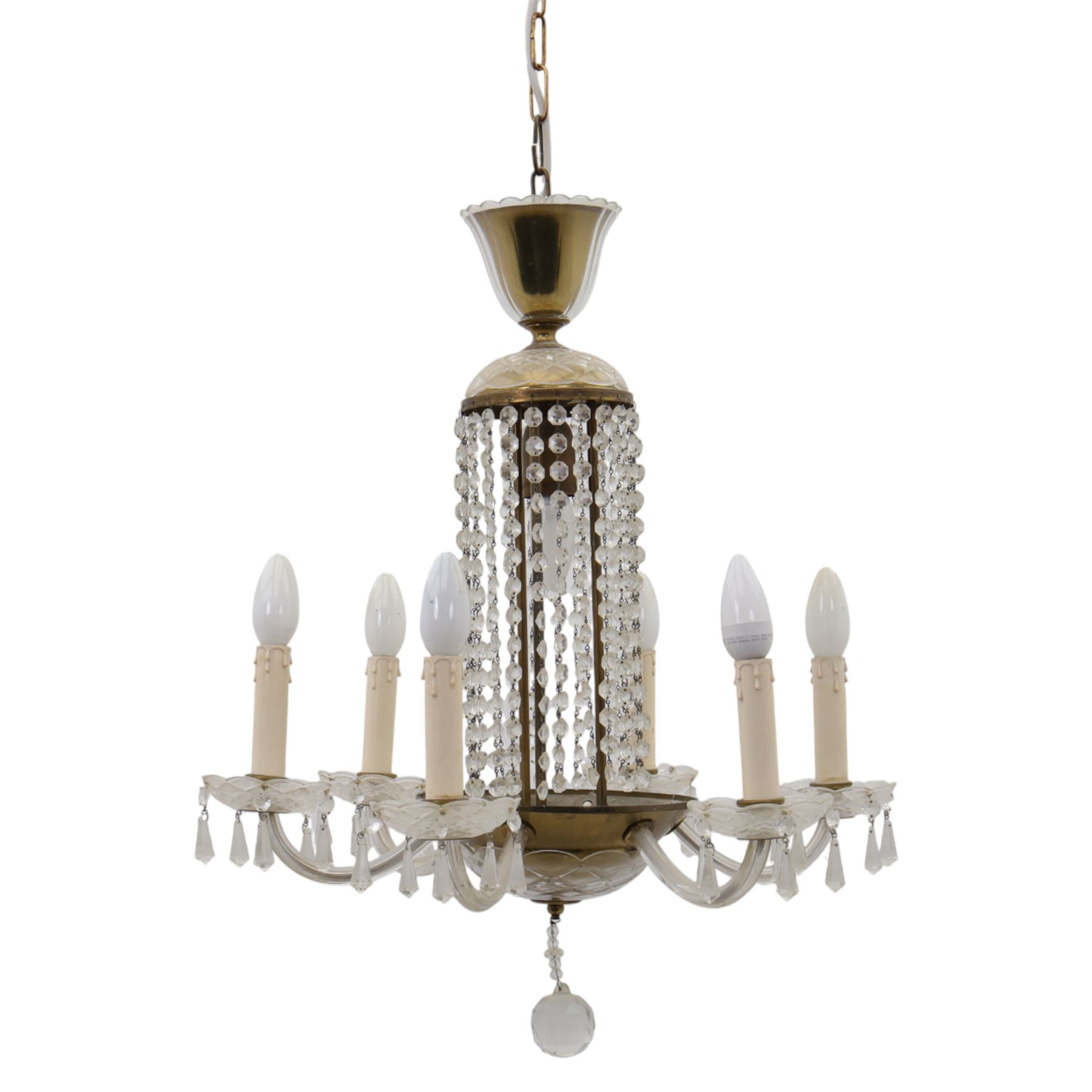 Early 20th century Continental glass and brass six branch chandelier, the central baluster column hung with graduated faceted glass drops, issuing six scrolling glass arms each fitted with candle sconces and drip pans, suspended from a fluted glass canopy