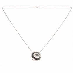 9ct white gold diamond swirl pendant necklace, circular pendant pave set with black and white diamonds, on a fine trace link chain necklace, both hallmarked, total diamond weight approx 1.55 carat