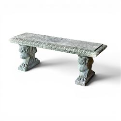 Ornate weathered cast stone rectangular garden bench, raised on winged griffin supports, square plinth bases
