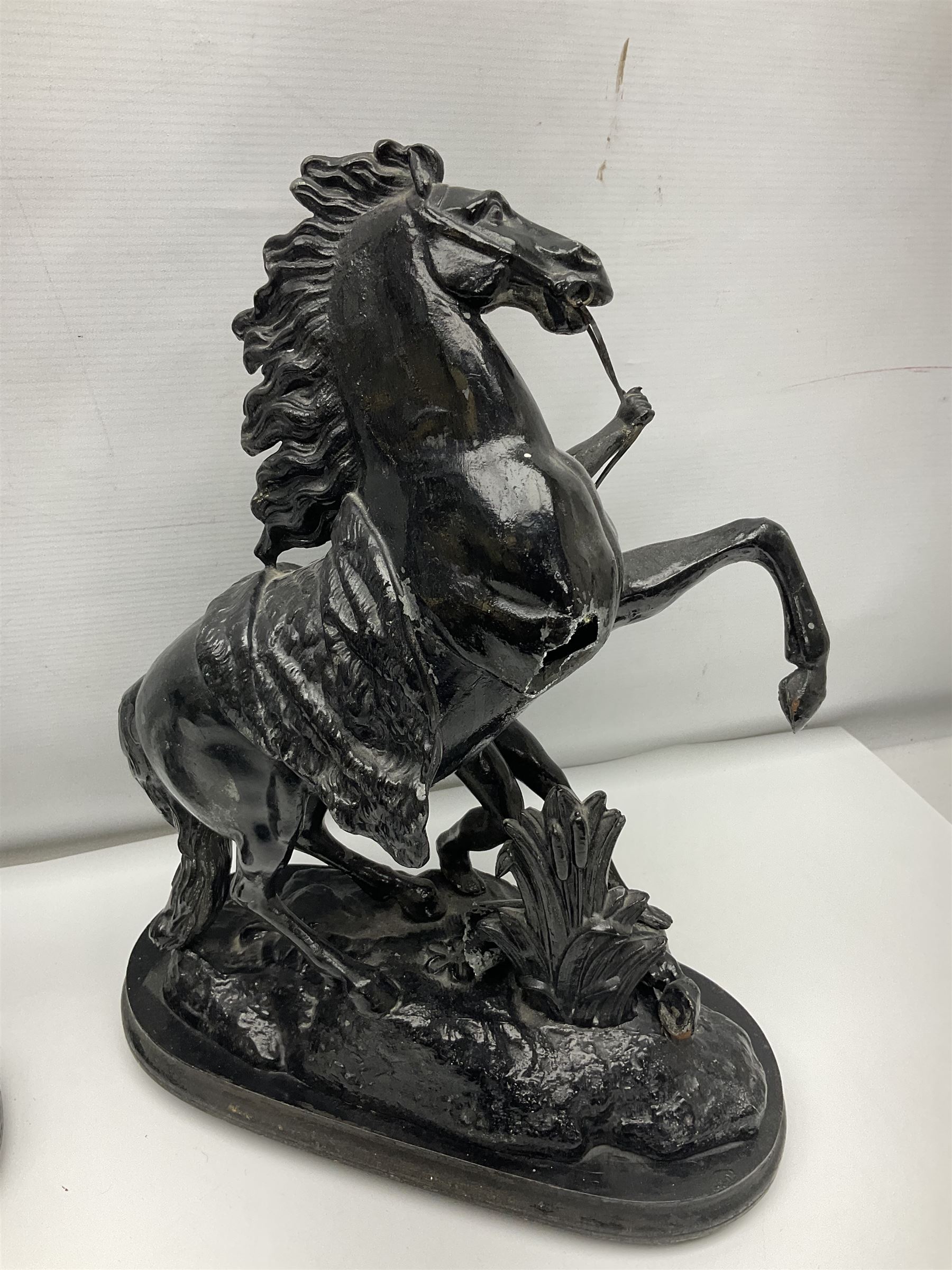 Pair of spelter figural statues of man and rearing horse, height 44cm and 42cm