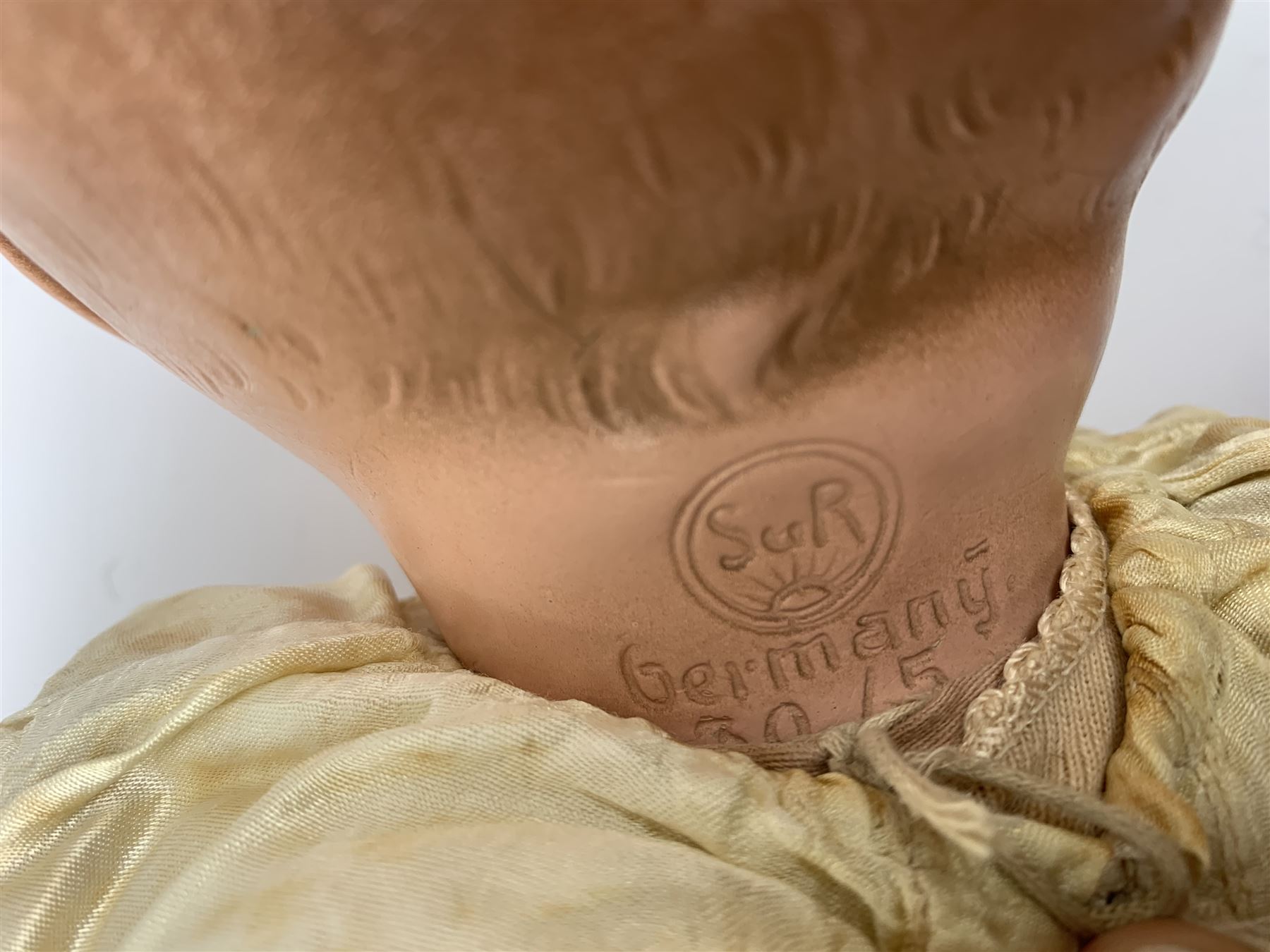 Seyfarth & Reinhardt composition head baby doll with moulded hair, sleeping flirty eyes, open mouth with one tooth and tongue and soft body with composition jointed limbs, marked 'SuR Germany 30/5' H47cm; together with a Golborne Dolls 'Golborne Beauty' composition head and body bride doll, marked 'F.P.23' in original box H63cm (2)