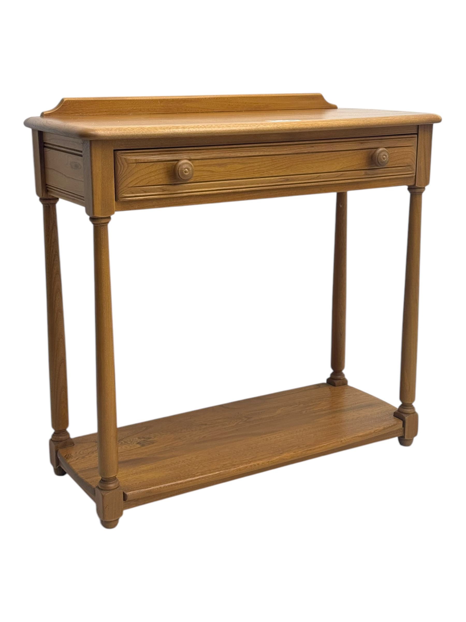 Lucian Ercolani for Ercol - mid 20th century light elm console table, rectangular top with raised gallery back over full-width frieze drawers, raised on tapered supports united by undertier 