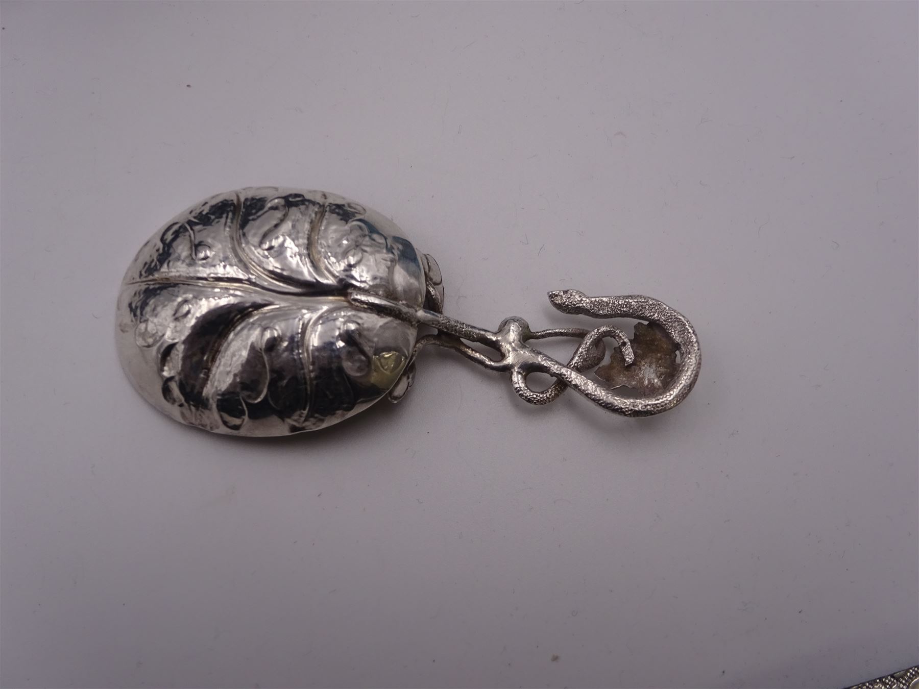 Unusual Victorian silver caddy spoon, the oval parcel gilt bowl embossed with leaf, leading to a flower head mounted tendril handle also detailed with leaf, hallmarked Hilliard & Thomason, Birmingham 1853, L8.5cm, approximate weight 0.49ozt (15.3 grams)