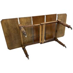 Late Victorian oak telescopic extending dining table, rectangular moulded top with canted corners, three additional leaves, on turned and reeded supports with brass and ceramic castors