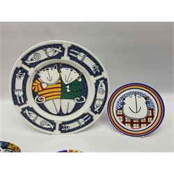 Modern studio pottery by Josie Firmin, to include cup and saucer, three espresso cups and saucers, pair of egg cups etc, each hand painted with varying cartoon cat designs
