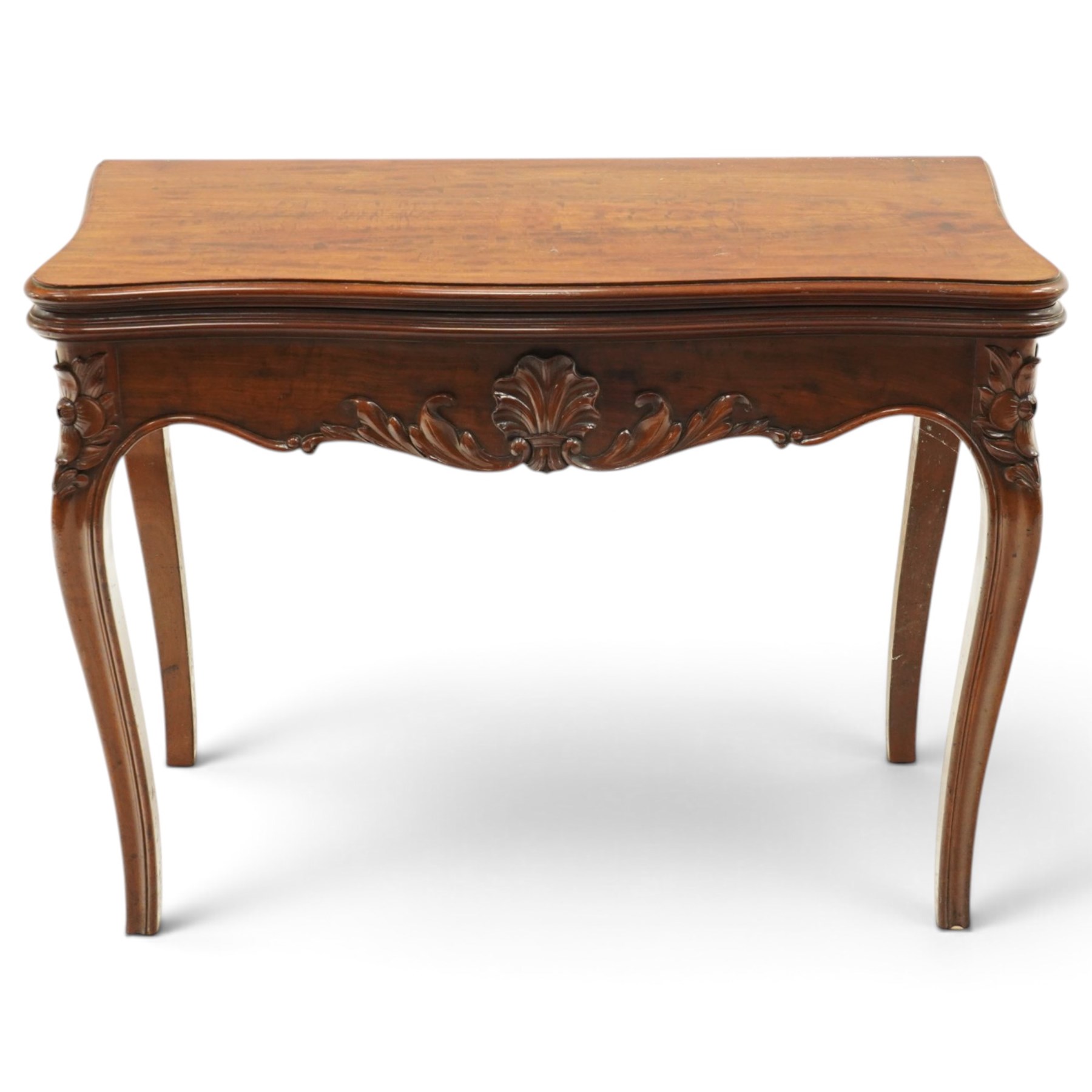 Victorian carved mahogany card table, shaped rectangular top with hinged fold-over top enclosing baize lined interior, supported on rear draw-supports, the frieze carved with anthemion and acanthus leaves, on cabriole legs