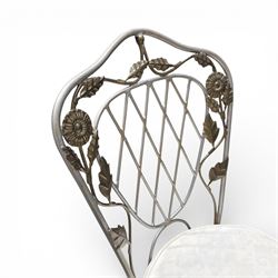 Wrought iron garden dining table with leaf decoration, and set of four matching chairs