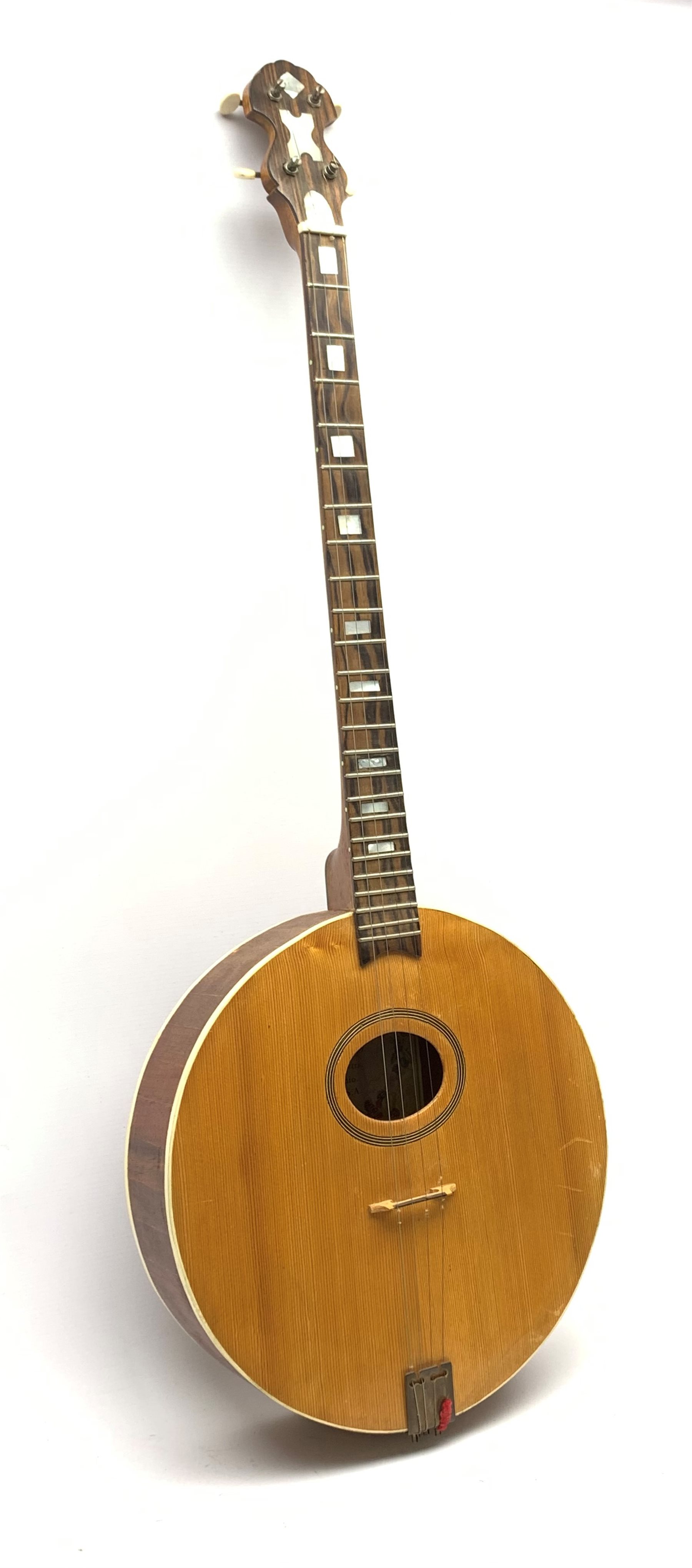 Four-string banjo guitar with mahogany circular back and sides and spruce top, mother-of-pearl inlaid fingerboard and headstock, bears humorous label 'Fender Bedpanjo', L95cm