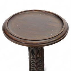 Late 20th century carved mahogany torchère stand, dished top above heavily carved column, with turned elements on moulded square base upon bun feet