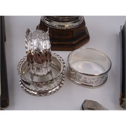 Group of silver, including twin handled trophy, of plain circular form and personal engraving, hallmarked William Neale & Son Ltd, Birmingham 1937, upon wooden base, together with three silver napkin rings, silver pusher, pair of silver sugar tongs and a collection of silver and enamel souvenir spoons, all hallmarked 