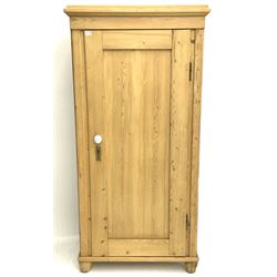 Solid pine single wardrobe, panelled door enclosing hanging rail above single drawer, shaped block supports 