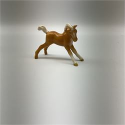 Beswick Palomino prancing Arab model no 1261, together with a Palomino foal model no 815, both with printed mark beneath.  