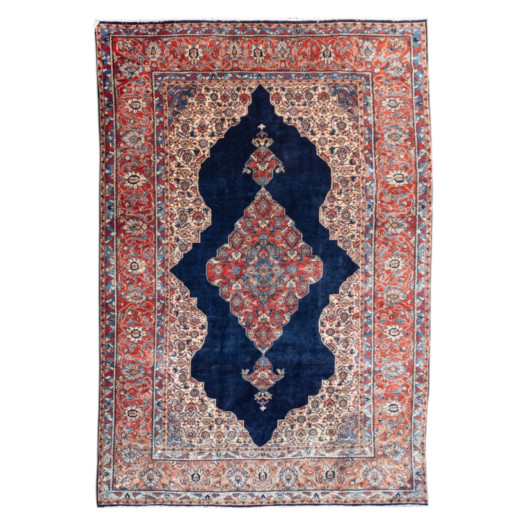 Large West Persian Bidjar hand-knotted carpet, deep indigo field with central medallion with pendants issuing an all-over design of scrolling vines, palmettes, and floral sprays, within conforming spandrels, enclosed a broad madder red palmette, and vine border framed by guard stripes, in a palette, of indigo, madder red and ivory tones, with cotton fringe ends 