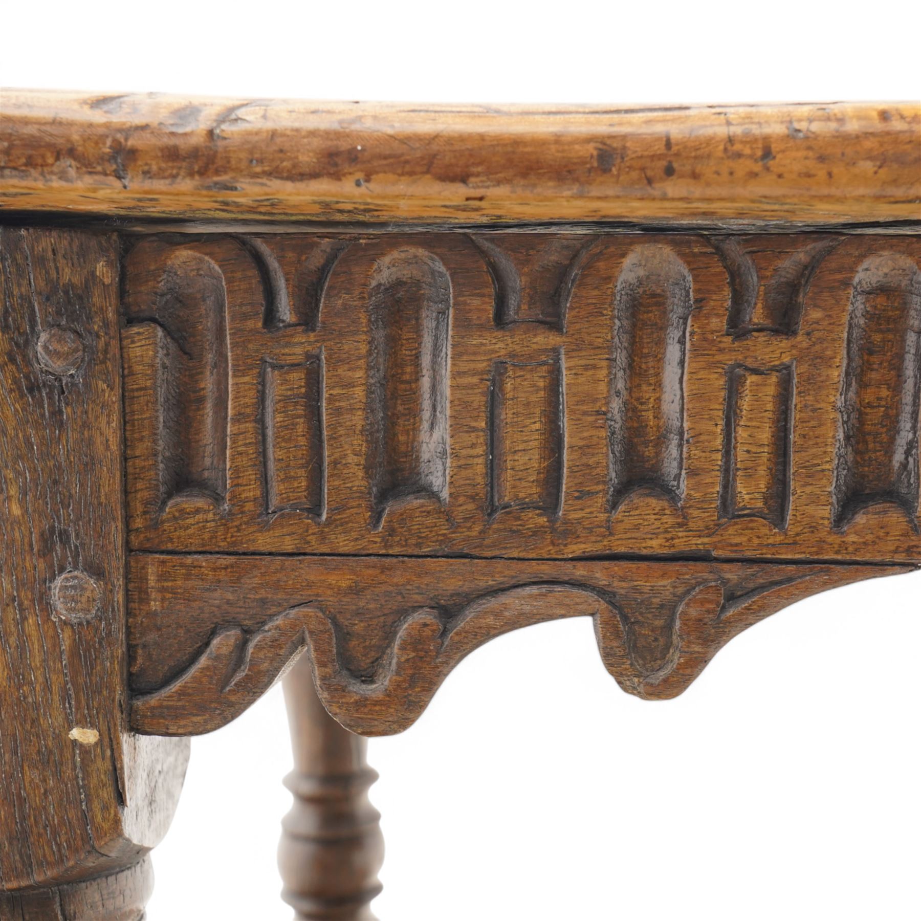 Charles I rectangular joined oak and elm refectory table, the frieze carved with repeated arch motifs, pearwood top above four turned supports united by horizontal stretcher, first half 17th century
Provenance: Purchased from Thorpe & Foster of Dorking in 1971
