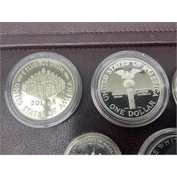 Five United States of America commemorative silver proof coins, comprising 1986, 1987, 1989, 1992 one dollars and 1982 half dollar, all with certificates