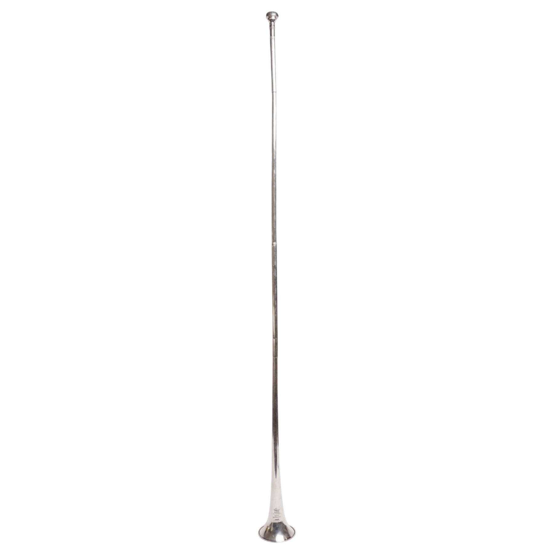 Boosey & Co. (295 Regent Street London) - Late Victorian silver plated sectional coaching horn of tapering form with flared bell, the mouthpiece stamped Vincent Bach Corp 7C surmounting the long tube with two ferrules, stamped to the bell with serial no. 39065, L128cm; with associated leather sleeve case