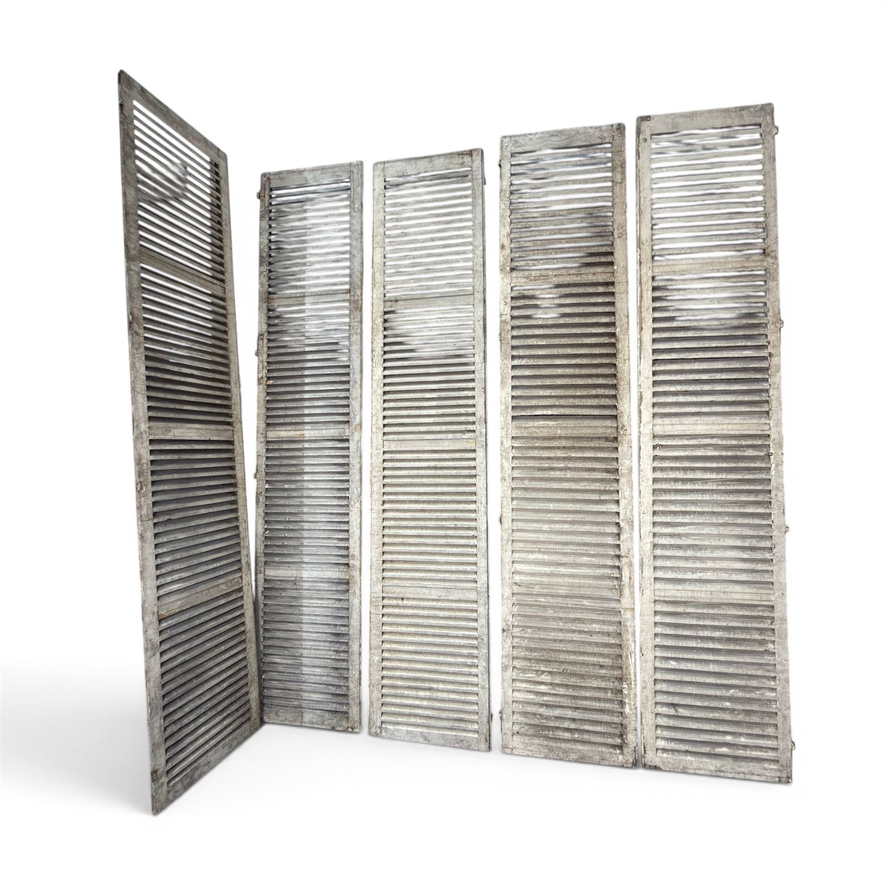 Five 19th century full height French Chateau louvre doors, pitch pine painted in cream finish, two having iron rod hinges, dimensions approx.