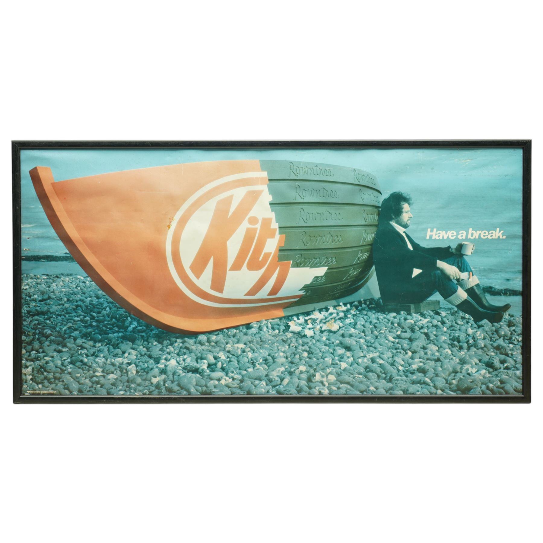 Original Rowntree Mackintosh (Rowntrees) advertising poster for KitKat - 'Have a Break', colour poster depicting a KitKat boat on a beach with a man drinking a cup of tea 38cm x 75cm 
Provenance: from the personal collection of David Lamb, former advertising manager at Rowntree Mackintosh, York