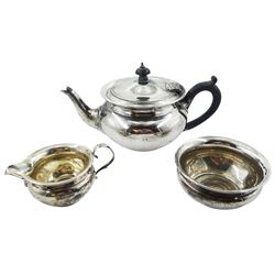 Early 20th century silver bachelors three piece tea service, comprising teapot, milk jug and open sugar bowl, each of squat rounded form, the teapot with ebonised handle and finial to the hinged cover, hallmarked Pearce & Sons, London 1912, teapot H10.5cm sugar bowl D9.5cm, approximate gross weight 15.15 ozt (471.5 grams)