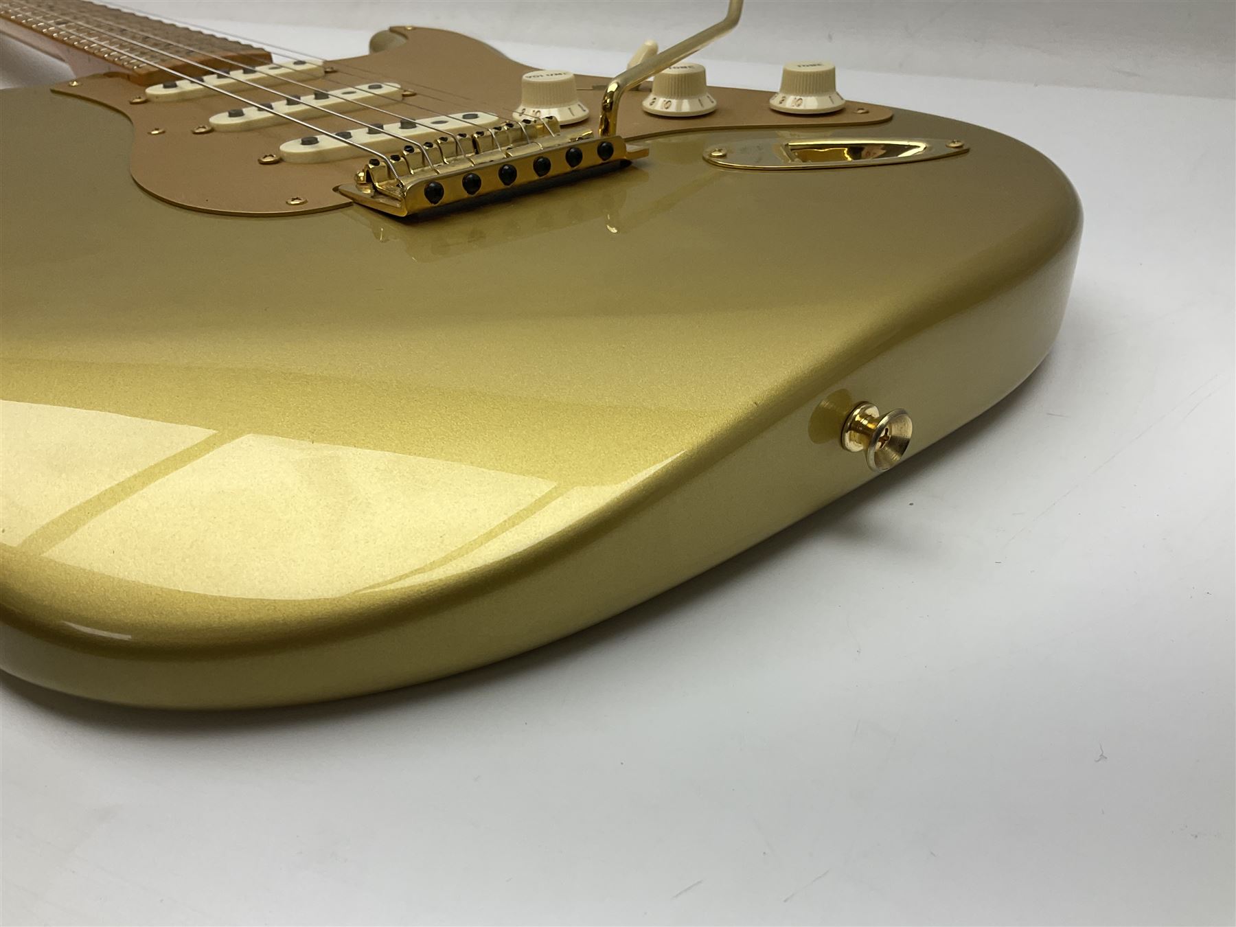 Fender Stratocaster 50th Anniversary 2004 metallic gold electric guitar; serial no.MZ4116369; L98cm; in Spider fitted case with owners manual and other paperwork, strap and belt buckle etc