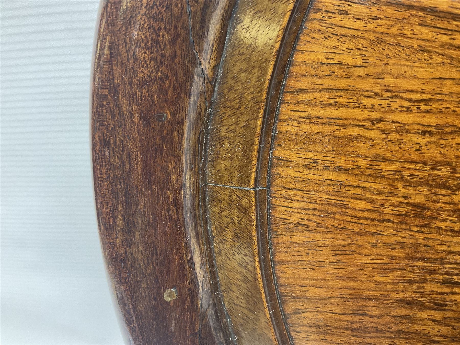 Late 19th/early 20th century mahogany and marquetry inlaid tray, of oval form with twin scrolled handles and moulded border, the central panel inlaid with figures seated at a table drinking tea, L99cm