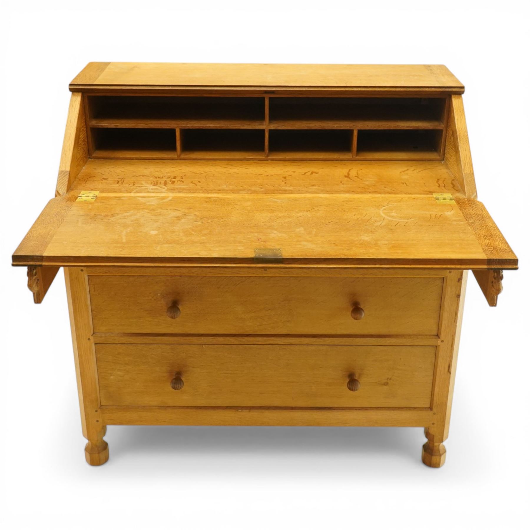Mouseman - oak adzed bureau, fall front with carved mouse lopers, with fitted interior, above two short over two long drawers, by the workshop of Robert Thompson of Kilburn
