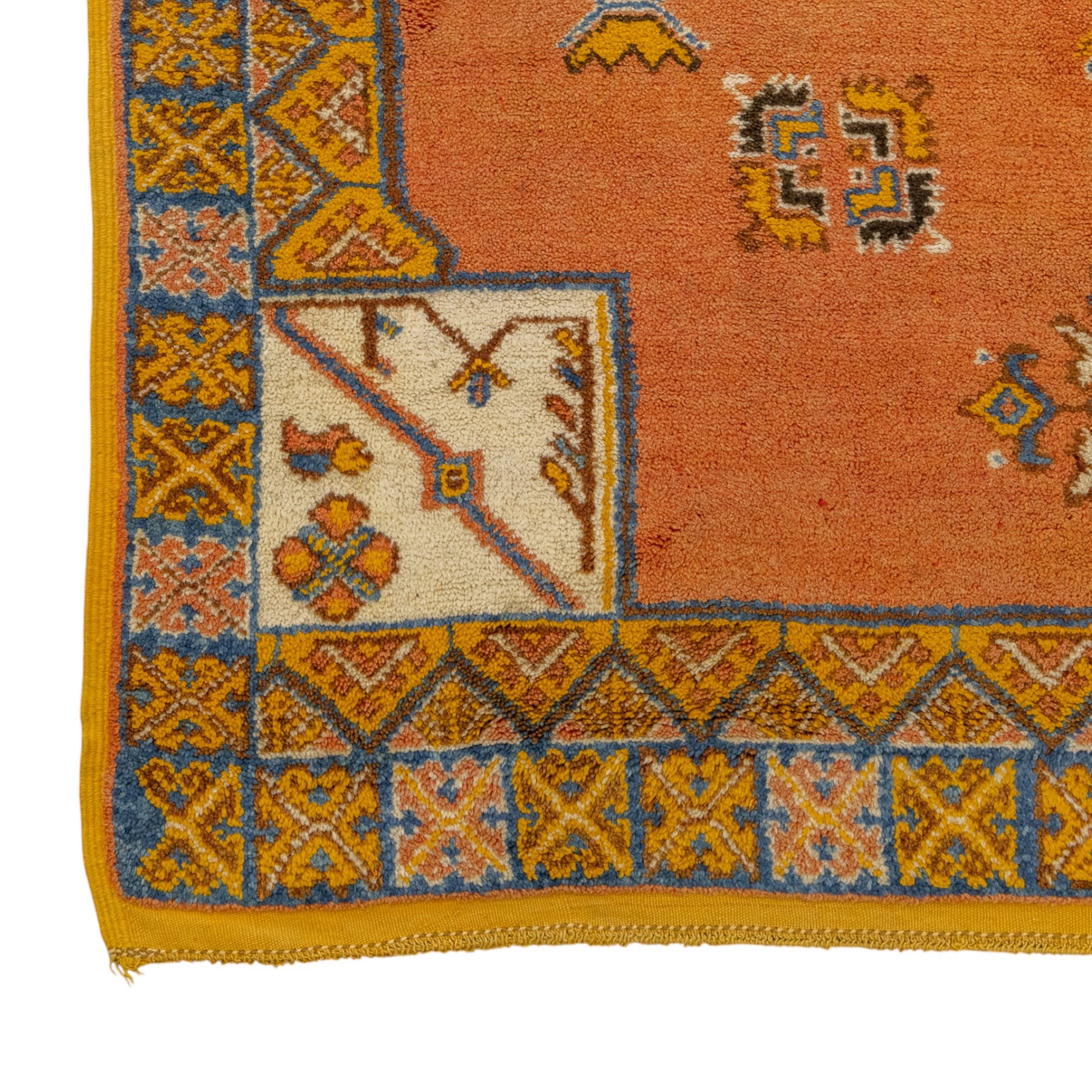Turkish Anatolian hand-knotted carpet, salmon ground centred by a blue and cream octagonal medallion, scattered with geometric floral and tribal motifs, cream spandrels and yellow geometric border
