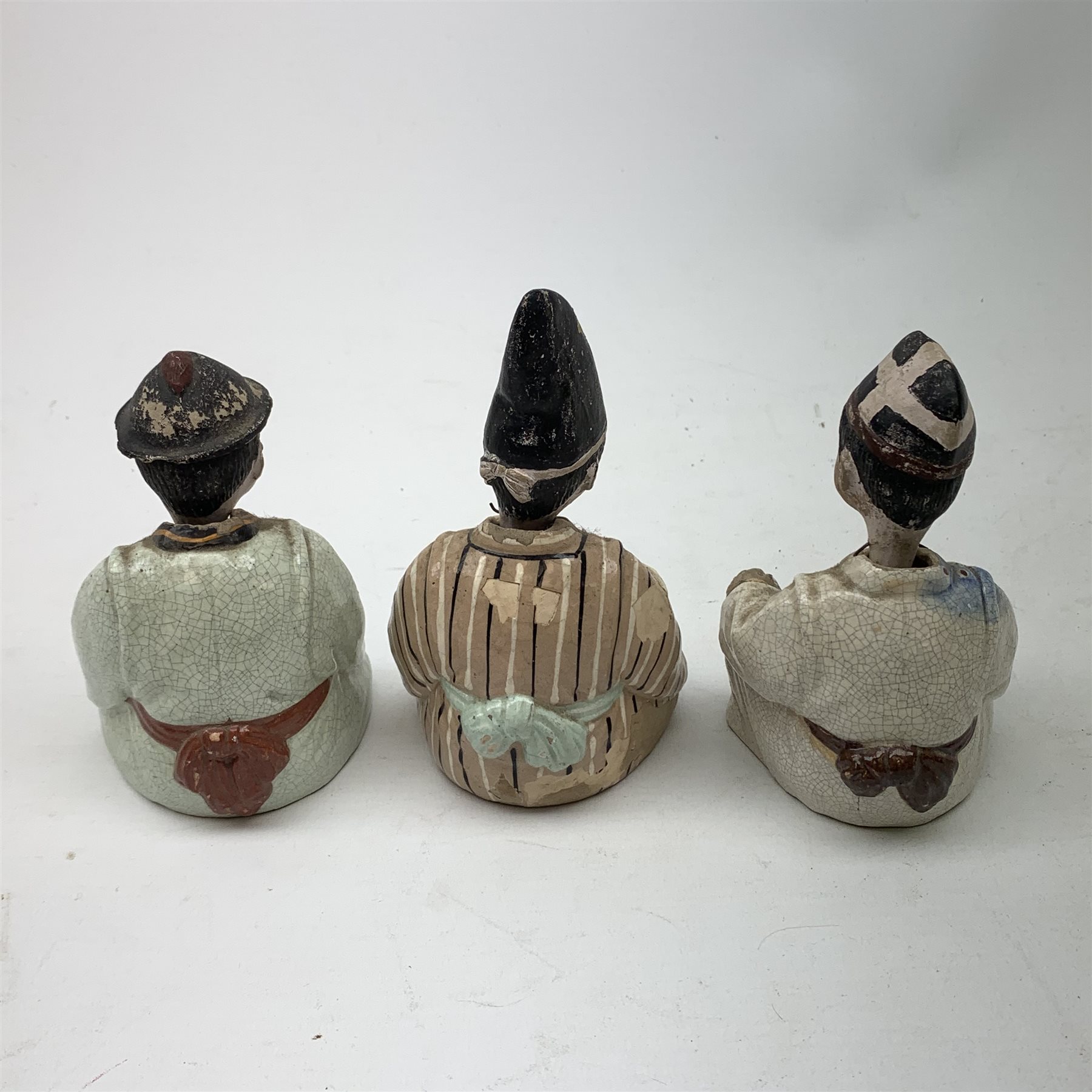 Three Japanese earthenware nodding head figures, each modelled as a seated male, tallest H13.5cm.  