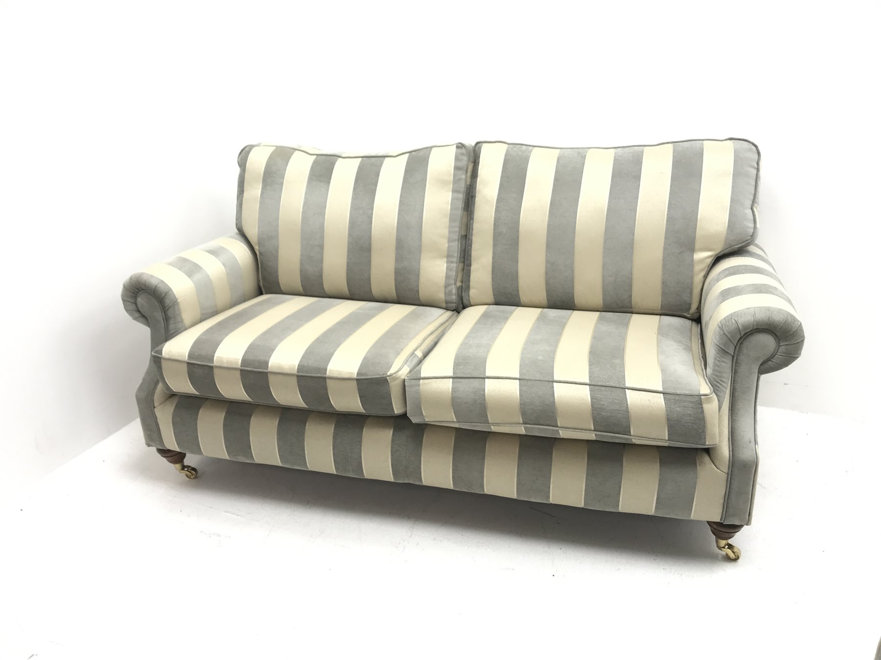 Alstons two seat Amberley sofa upholstered in grey and pale gold stripes, turned supports on castors (W195cm) and two matching armchairs (W92cm)