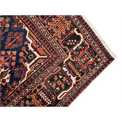 Persian Joshgan red ground rug, the medallion, field and spandrels decorated with clusters of Pitrak and tree of life motifs, the border with repeating design decorated with stylised plant motifs, within guard stripes