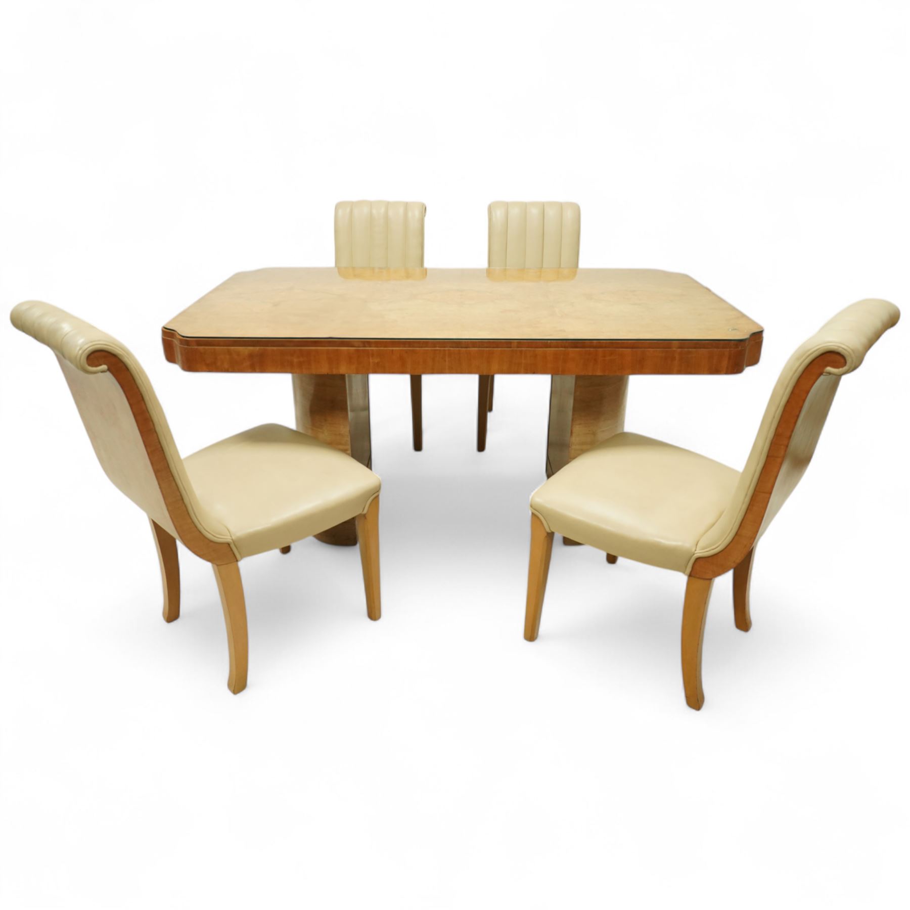 In the manner of Harry & Lou Epstein - Art Deco figured walnut veneered dining table, rectangular top with canted corners and glass protective top, edge with gently canted profile, on two rounded drum-shaped pedestals together with a set of four mid-century style walnut chairs, with elegant scroll and walnut veneered backs, upholstered in a light cream leather, 54x44x96cm