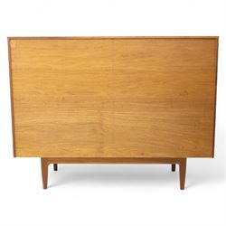 Sutcliffe of Todmorden - Mid 20th century teak highboard, ‘S-Form’ range, the upper section with glazed and panelled sliding doors above open shelving, over a base fitted with twin drawers and cupboards, all with moulded recessed handles, on shaped tapering supports, reflecting the sleek organic styling characteristic of 1960s British modern furniture design