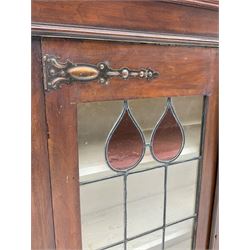 Early 20th century walnut cabinet, fitted with leaded and stained glazed doors