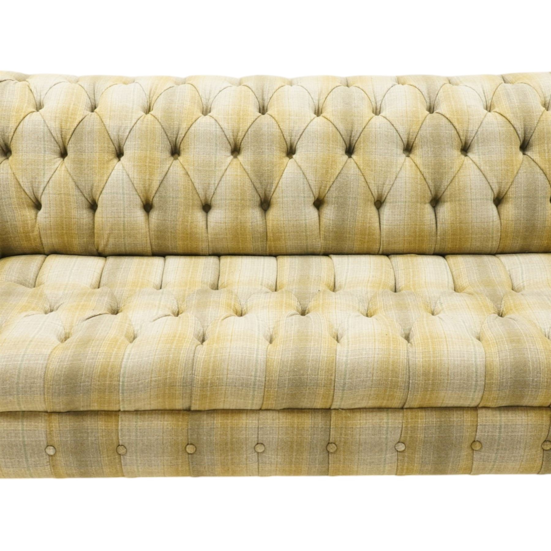 Late 20th century Chesterfield style two seat sofa, upholstered in muted green and yellow tartan fabric with buttoned back, arms and seat, on turned front supports with brass castors