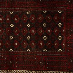 Three rugs,  comprising a Baluch rug in crimson ground, 179x97cm, a Tekke Bokhara rug in crimson ground, 201x132cm, and a Bokhara rug in ochre ground, 125x175cm 