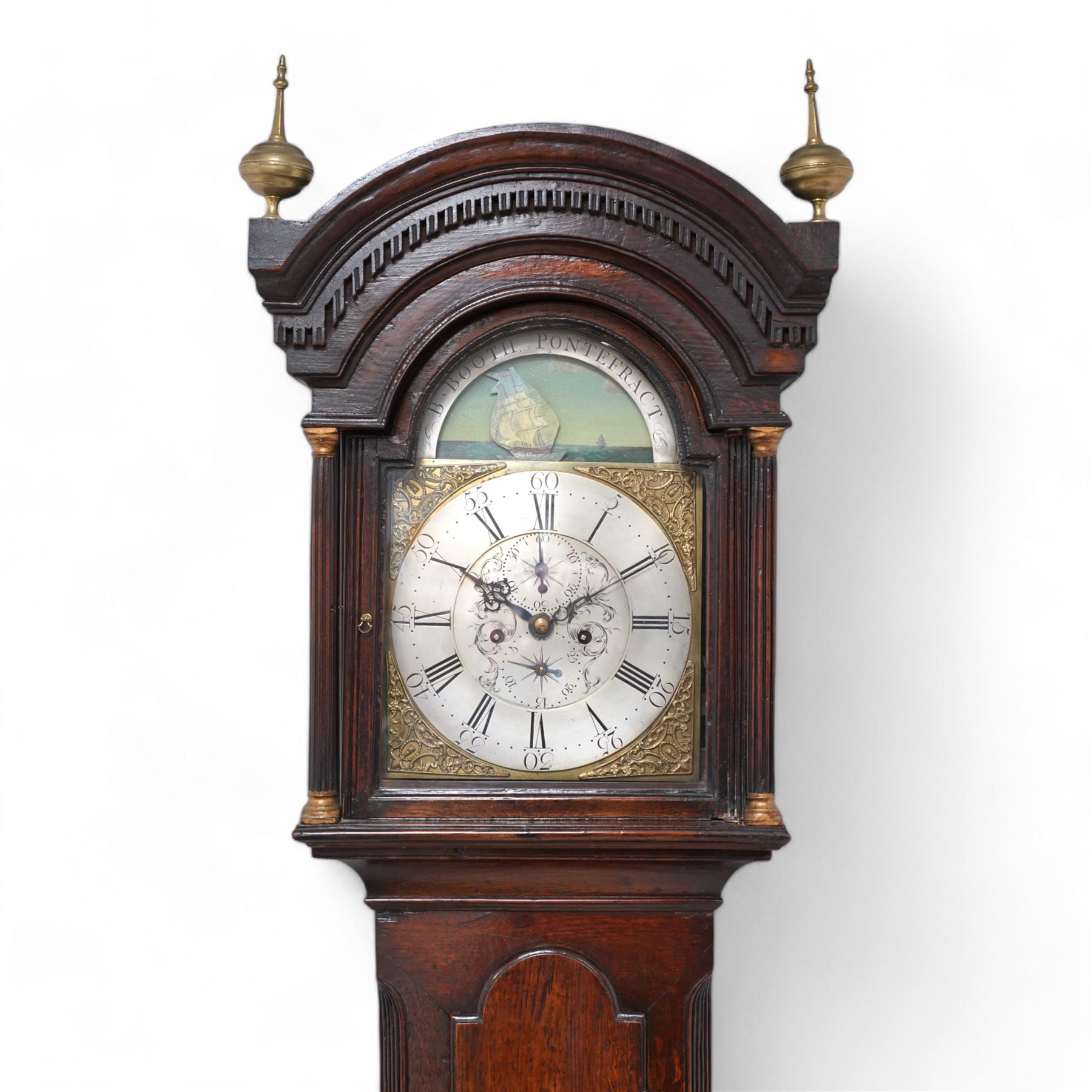 Benjamin Booth of Pontefract - 8-day oak longcase clock c1790. with a stepped broken arched pediment, deep cornice with dog tooth moulding and two brass finials, break arch hood door with flanking reeded pilasters and gesso capitals, trunk with canted corners and a long break arch topped door, on a rectangular plinth with applied skirting, brass dial with rocking ship automata and makers name to to the arch, with bordered cast spandrels and an silvered engraved dial centre, chapter with Roman numerals and five minute Arabic's, matching steel hands , calendar and seconds dials, movement pinned to a rack striking movement with a recoil anchor escapement. With weights, pendulum and key.
Benjamin Booth is recorded as being apprenticed to John Booth of Huddersfield in 1760 and working in Pontefract c1766 until his death in 1806. 