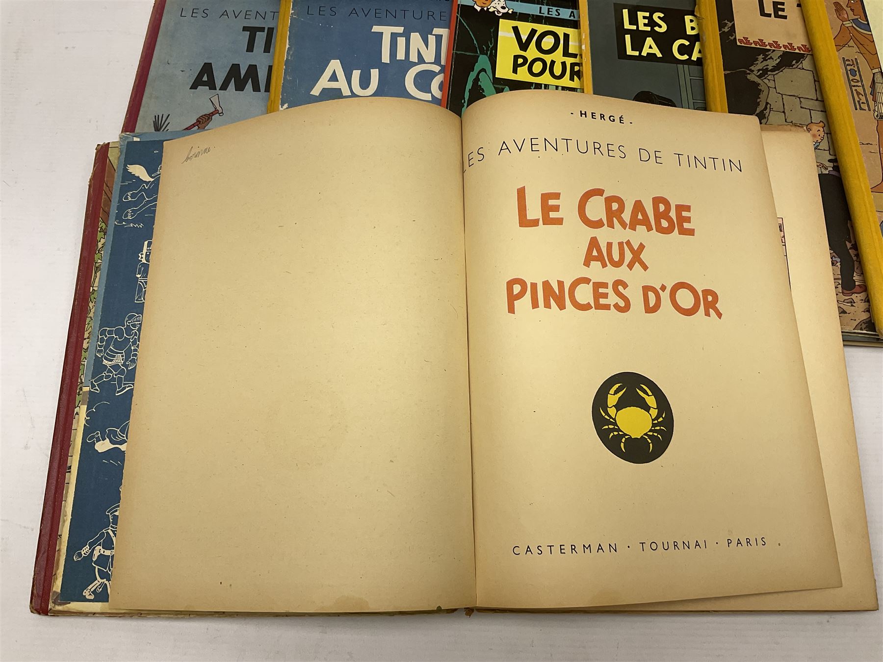 Twenty one first edition Herge, 'The Adventures of Tin Tin' books published by Casterman Bruxelles, with French text and coloured comic strip illustrations throughout; comprising Tintin Au Congo 1946, Tintin En Amerique 1946, Les Cigares du Pharaon 1955, Le Lotus Bleu 1946, L'Oreille Cassee 1943, L'ile Noire 1943, Le Sceptre d O'ttokar 1947, Le Crabe Aux Pinces D'or 1943, L'Etoile Mysterieuse 1942, Le Secret de la Licorne 1943, Le Tresors de Rackan Le Rouge 1945, Les 7 Boules de Cristal 1948, Le Temple du Soleil 1949, Au Pays de L'Or Noir 1950, Objectif Lune 1953, On a Marche sur la Lune 1954, L'Affaire Tournesol 1956, Coke en Stock 1958, Tintin au Tibet 1960, Les Bijous de la Castafiore 1963 and Vol 714 Pour Sydney 1968
