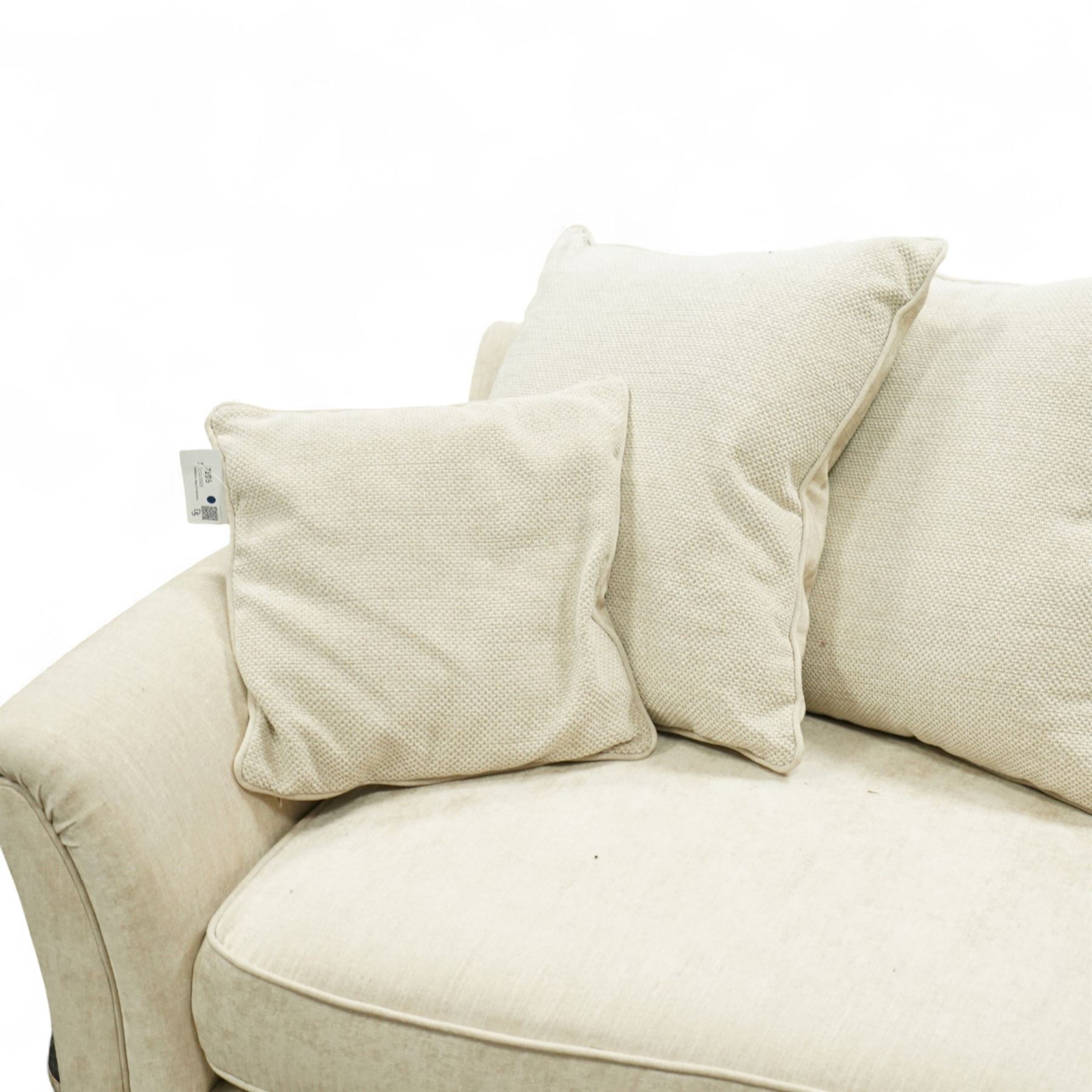 Parker Knoll - contemporary beige upholstered two seat sofa, with flared scroll arms and loose back and seat cushions, standing on stained tapered block feet