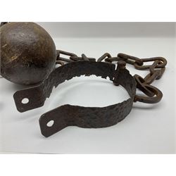 Late 19th/early 20th century prisoners iron ball and chain, with leg manacle; small cannon ball and grape shot