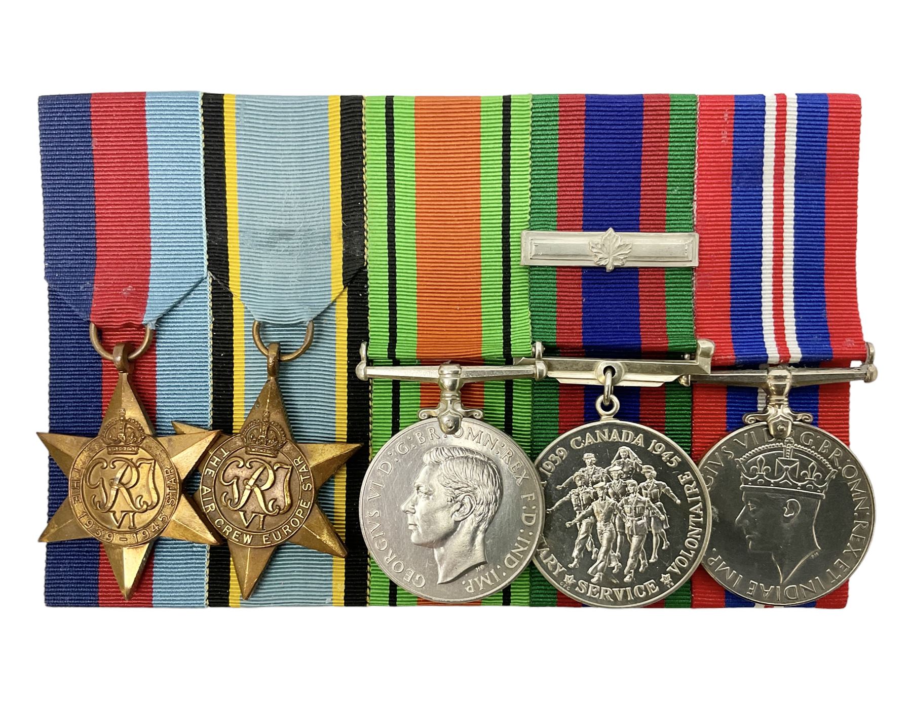 Group of five medals comprising 1939-1945 War Medal, Defence Medal, 1939-1945 Star, Air Crew Europe Star and Canadian Volunteer Service Medal with maple leaf clasp; all with ribbons and mounted on a display board