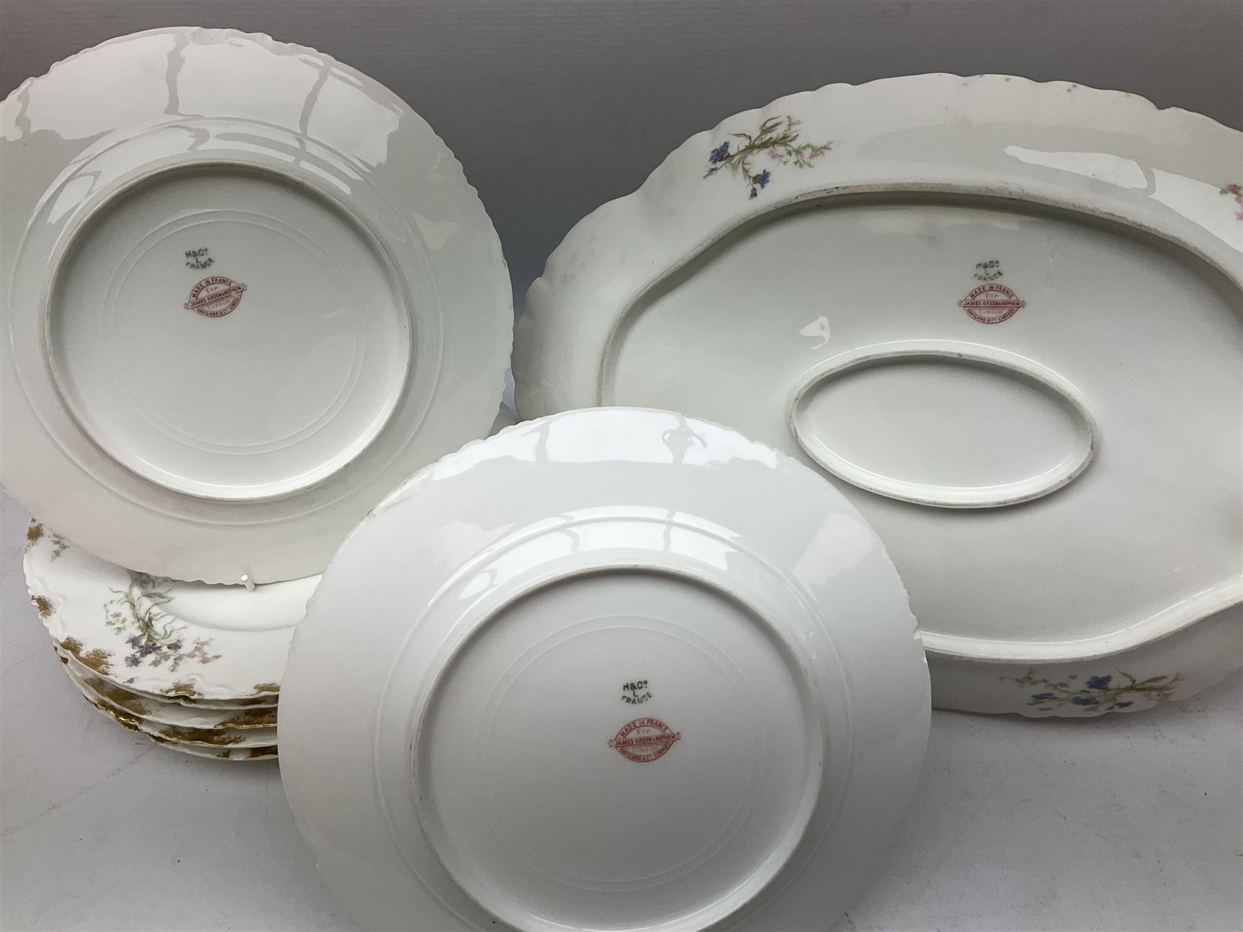 French Haviland Limoges part dinner service, decorated with floral sprays and gilding, to include two lidded tureens, thirteen plates, oval serving platter, etc, all stamped H & Co Made in France for James Green & Nephew (17) 