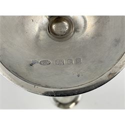 Pair of modern silver candlesticks by Stuart Devlin, the tapering parcel gilt stems with signature textured detailing, each supporting a fluted candle holder and upon a spreading circular foot, hallmarked Stuart Devlin, London 1973, H25cm