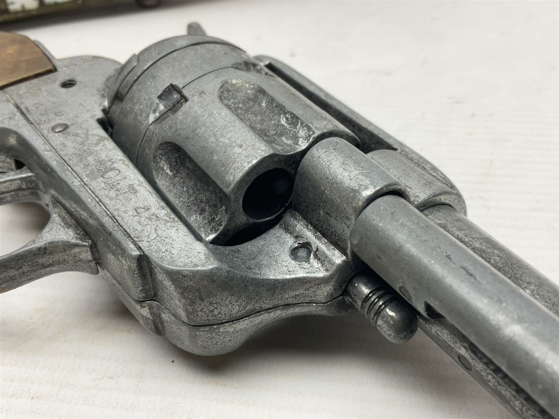 Modern non-firing reproduction Tower flintlock pistol marked with crowned GR and Tower to the lock, brass skull crusher butt and fittings L40cm overall; another Indian/Moorish reproduction flintlock pistol with mother-of-pearl inlay; and a modern die-cast replica Colt style revolver (3)