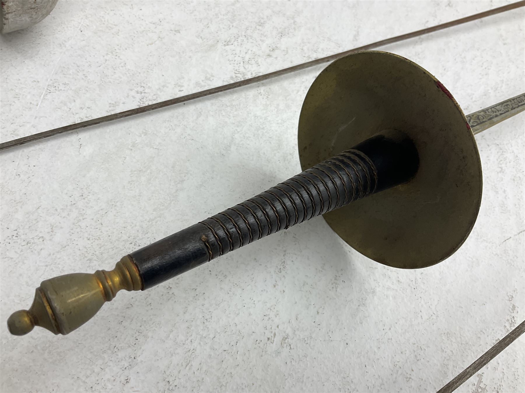 20th century Indian Tulwar sword with 71cm plain curving steel blade and iron hilt with extended langets, knopped grip and spiked pommel; in canvas covered wooden scabbard L87.5cm overall; together with five fencing swords comprising four foils and one epee, three marked Leon Paul, one in carrying case (6)