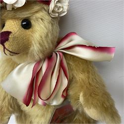 The Cotswold Bear Company - two teddy bears from ‘The Flower Collection’ comprising ‘Mayflower’ no.99/100, blonde mohair with dark pink flower crown and bow, H33cm; ‘Phoenix’ no. 99/100, blonde mohair with white and red rose flower crown and bow, H28cm; both with original labels and purchase receipt (2)