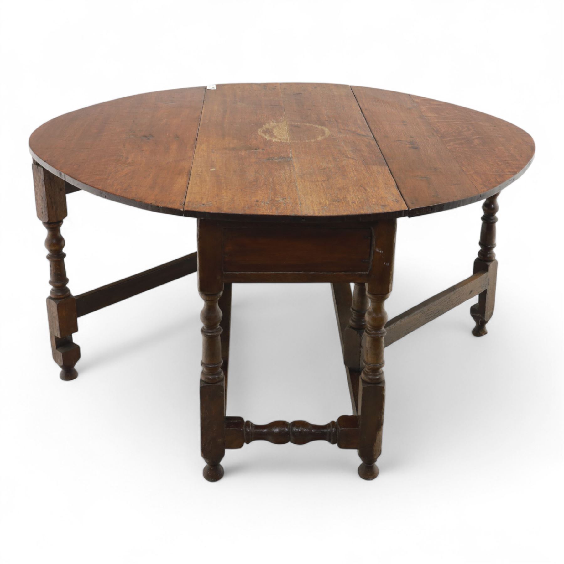 Early 19th century oak drop-leaf gateleg table, oval top above plain frieze, on ring turned legs joined by stretchers