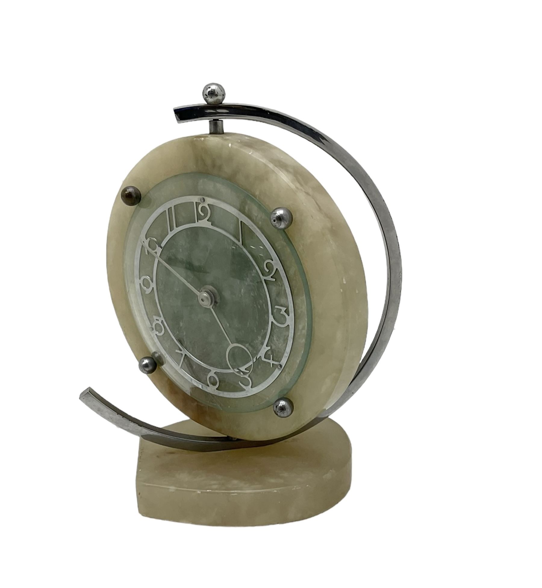 English 1920's Art Deco white-onyx mantel clock c1920, with a circular marble surround,  glass fronted chrome plated chapter with fretted Arabic numerals and conforming hands, movement and dial suspended in a semi-circular swivel gimbal mount, spring driven movement with a balance escapement, wound and set from the rear.