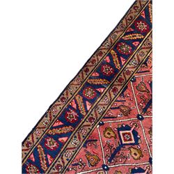 Persian Ardakan crimson ground rug, the field divided by lattice and decorated with stylised tree of life motifs, the border decorated with geometric flower heads, within guard stripes 