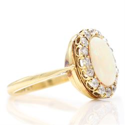 Early 20th century gold opal and diamond cluster ring, single oval cabochon opal, surrounded by sixteen old cut diamonds, stamped 18ct, total diamond weight approx 0.65 carat